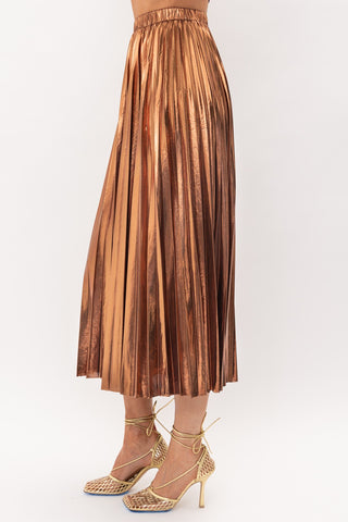 Metallic Bronze Midi Skirt on model in front of white backdrop. The model is wearing gold heels. 