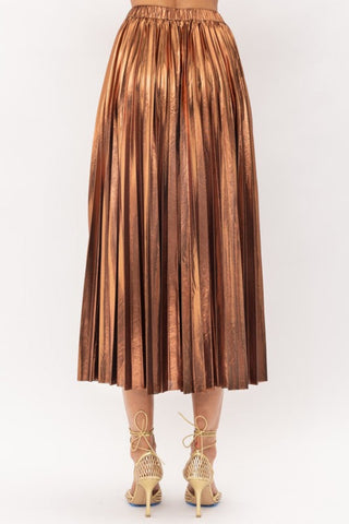 Metallic Bronze Midi Skirt on model in front of white backdrop. The model is wearing gold heels. This image is showing the dress from the back.
