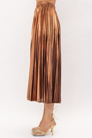 Metallic Bronze Midi Skirt on model in front of white backdrop. The model is wearing gold heels. 